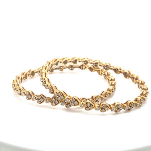 Radiant Heart 18K Yellow Gold Diamond Bangle - Heart-shaped motif with sparkling diamonds on rich gold backdrop.