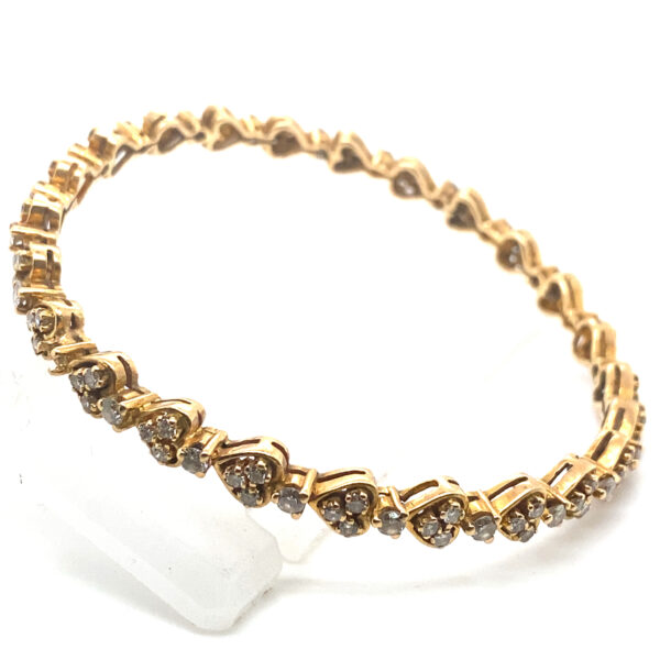 Radiant Heart 18K Yellow Gold Diamond Bangle - Heart-shaped motif with sparkling diamonds on rich gold backdrop.